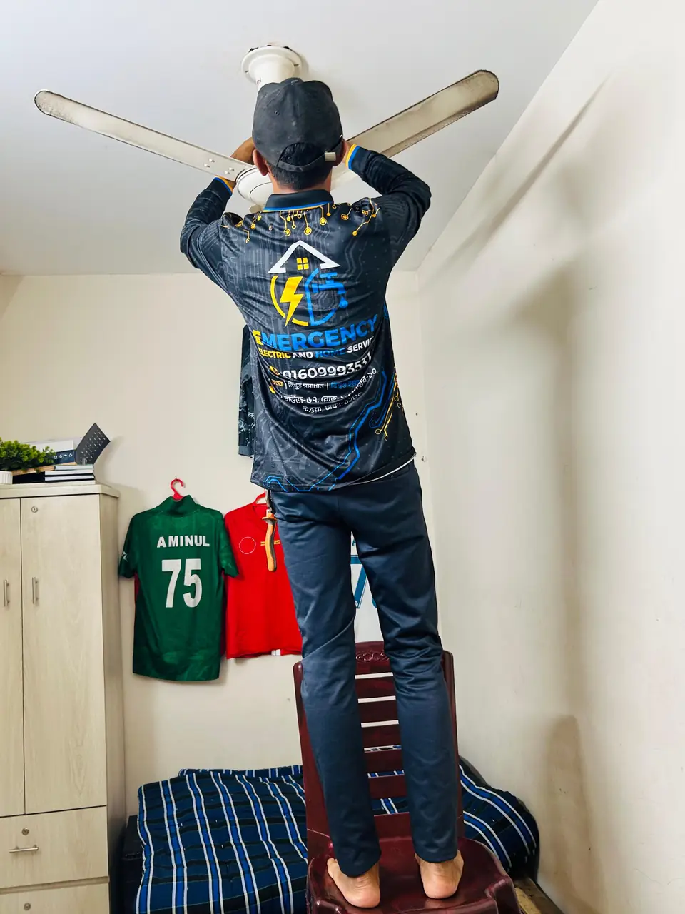 Ceiling fan being installed and balanced