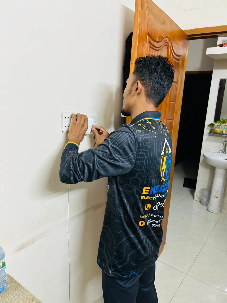 Electrician replacing a switch board in a flat